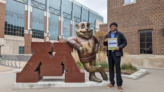 Koushik poses next to the Block M and Goldy Gopher statue on the East Bank of the U of M campus. 