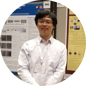 Lingkan Ding wearing a white button up and posed in front of information posters