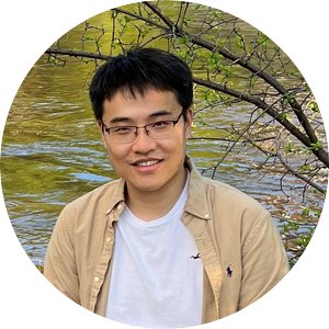  Licheng Liu smiling and posed in front of a tree and a body of water.
