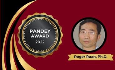 A poster of an award seal with Professor Roger Ruan's headshot to celebrate his receiving of the Pandey Award in 2022. 