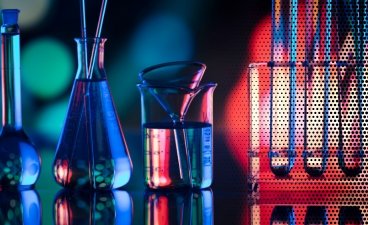a stock image of beakers and test tubes lit by blue and red light