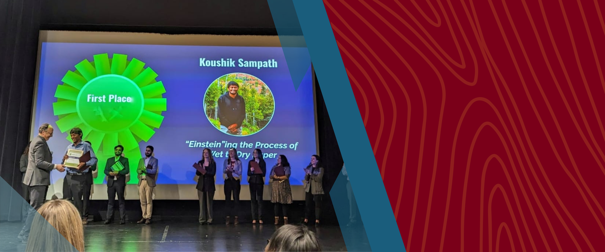 Koushik accepts his grand prize on stage during the three minute thesis competion on November 11th. 
