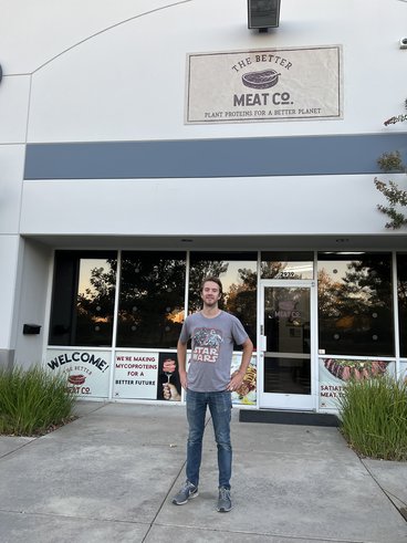 Van Lierop stands in front of better meat co. in California wearing a star wars tee shirt