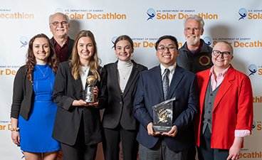A group photo of the NoBS club at the solar decathlon after receiving their grand prize at the competition.