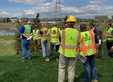Participants in the regulatory enforcement class gatheraround drainage ponds during class time. 