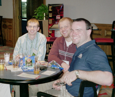 Dan Little, James Barsness, Michael Burns sit around a table at the U of M