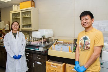 Professor Jiwei Zhang in his lab with graduate student Nandin Ganjoloo (left)