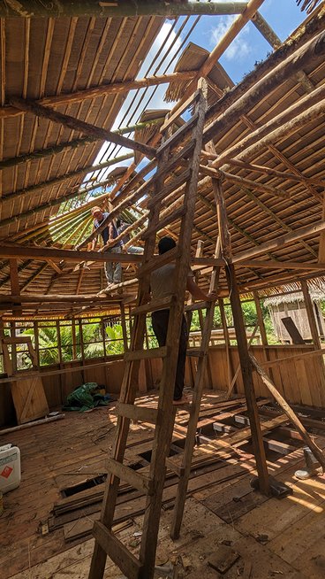 Workers build the roof of a birth house in a remote village in the Amazon.